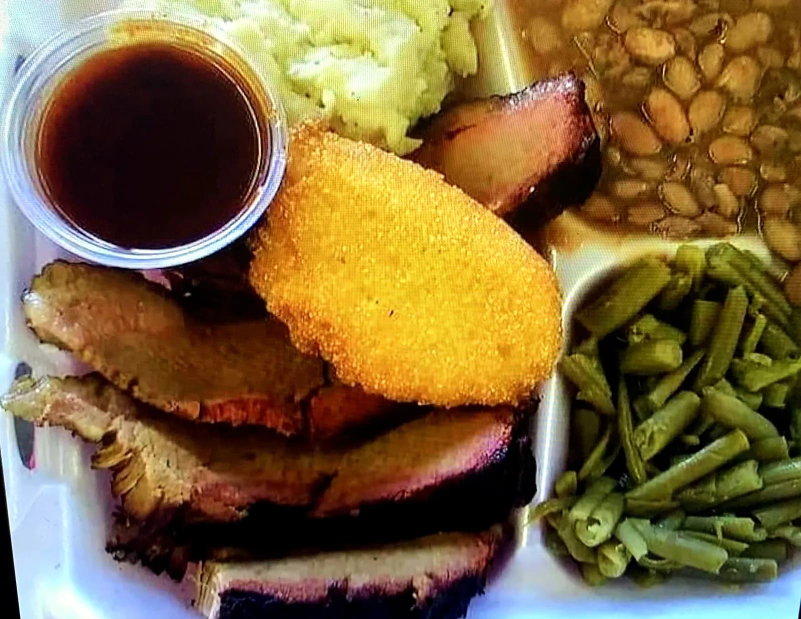 Brisket plate with beans, potatoes, green beans and cornbread