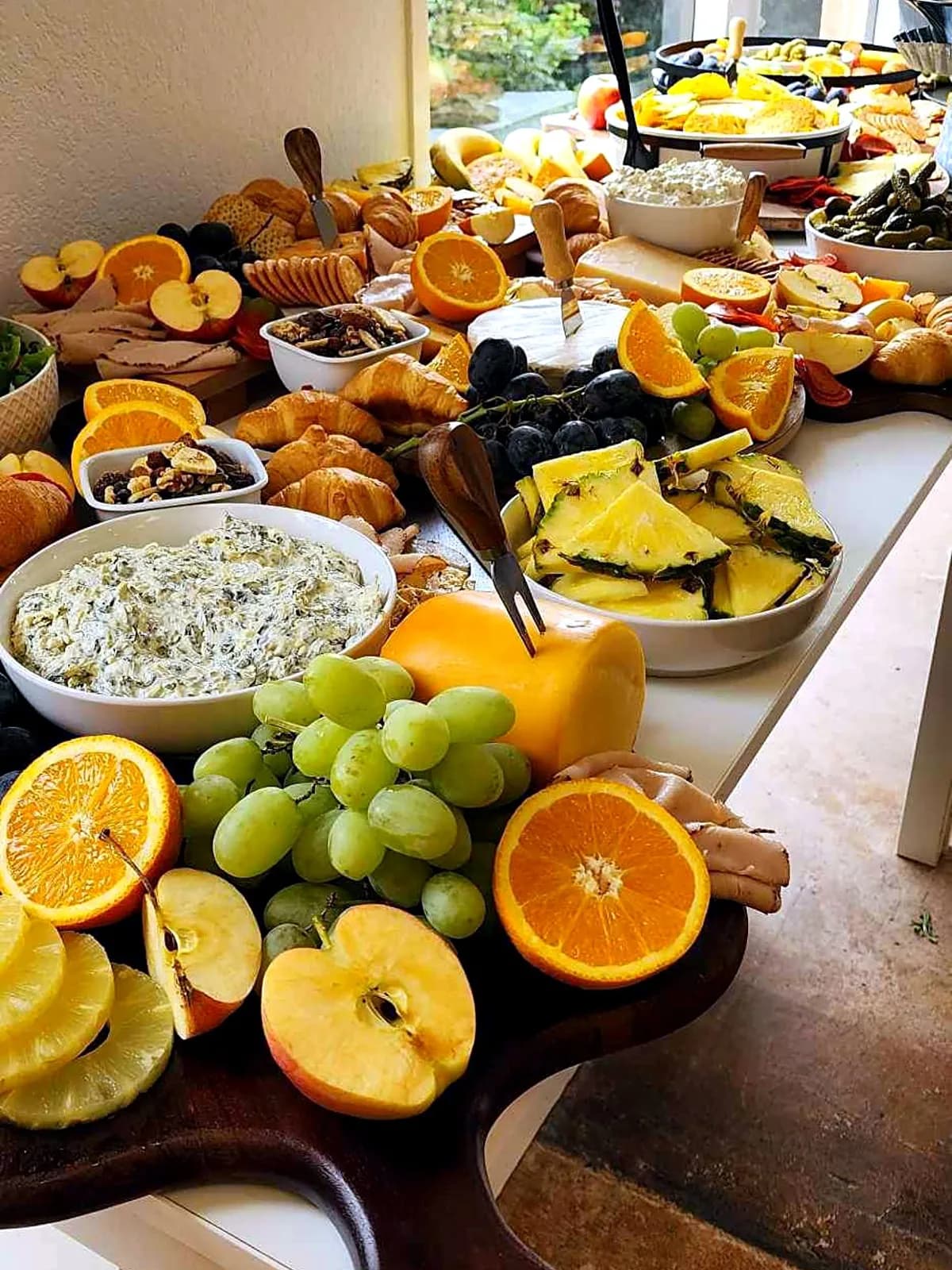 Grazing table with fruit, cheese, bread and dips